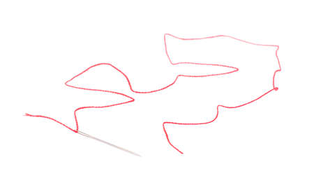 Needle with red thread and seam on white backgroundの写真素材
