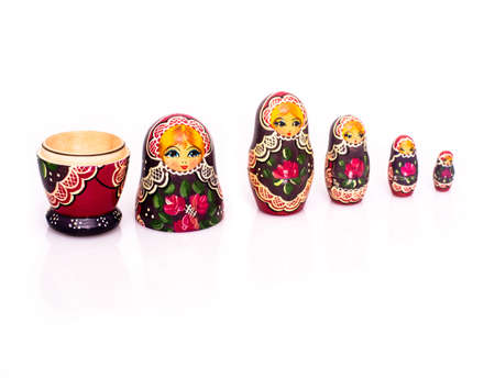 Russian nesting dolls ( babushkas or matryoshkas ) with reflection and shadows on white backgroundの写真素材