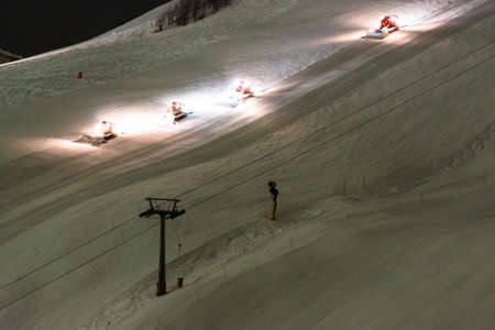 Snow groomer equipment at nightの写真素材