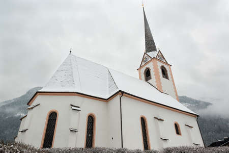 Beautiful church with mountainsの写真素材