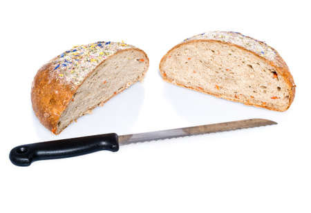 Two half loafs of bread with knife