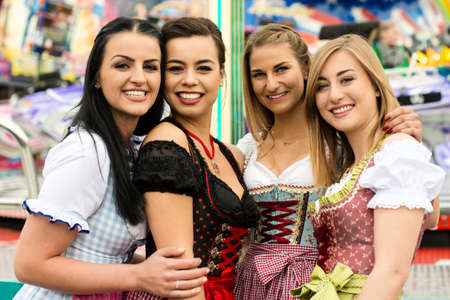 4 gorgeous young women at German funfairの写真素材