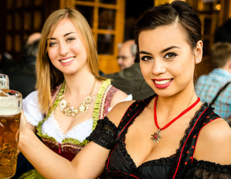 Girls drinking beer at Oktoberfestの写真素材