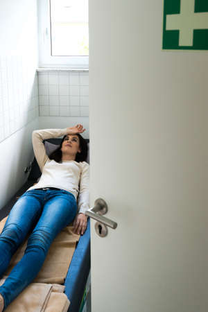 Young woman is relaxing in a quiet room of an officeの写真素材