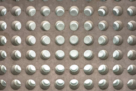 Abstract texture of a concrete roof with round glass inlets facing the skyの写真素材