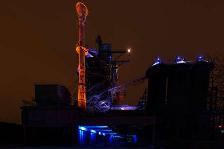 Night shot of Landschaftspark Nord, old illuminated industrial ruins available for the public in Duisburg, Germany. Landschaftspark Duisburg is a former coal and steel production plant abandoned in 1985 and converted into an industrial monument open for tの写真素材