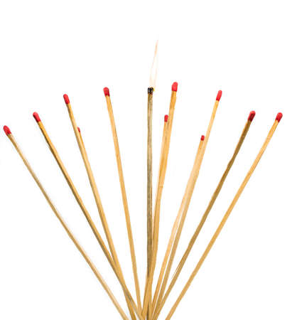 long wooden matches isolated on a white studio background, the one in the middle is lit