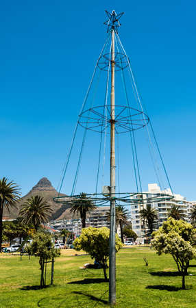 Cape Town, South Africa - November 11, 2016: Artificial Christmas tree beside the sea in Cape Town,...