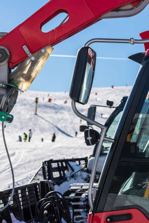 Skiers and snow-grooming machineの写真素材