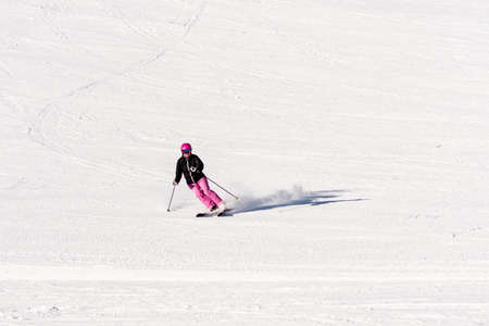 Female skier on empty ski slopeの写真素材