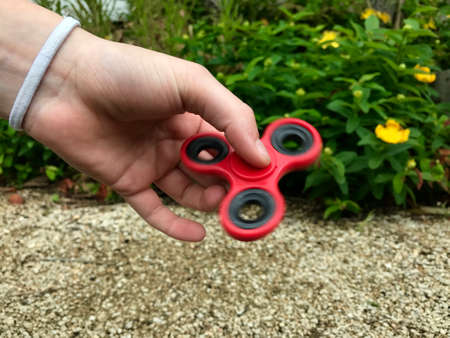 Girl holding popular new spinner gadgetの写真素材