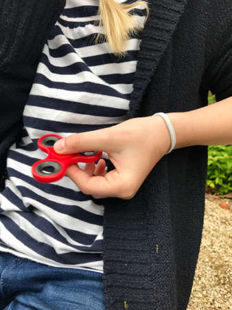 Girl holding popular new spinner gadgetの写真素材