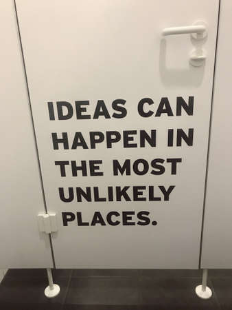 Ideas can happen in the most unlikely places text on a door.