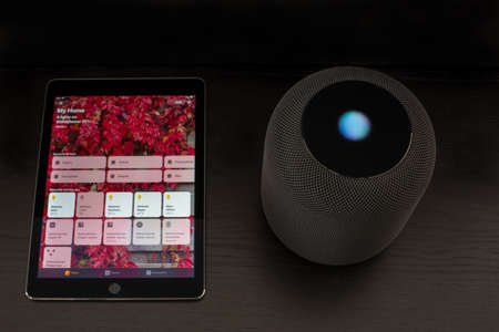 Smart home using an Apple HomePod speaker and the home app on the iPadのeditorial素材