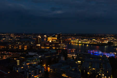 Aerial view of Hamburg, Germany in the evening with fireworks next to the new Elbphilharmony (Elphi)...