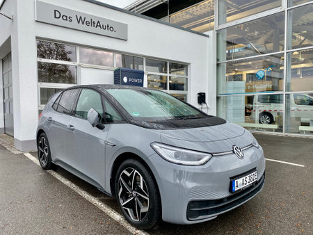 The new volkswagen id.3 electric car is charging at the Volkswagen car dealership in Augsburg, Germany.のeditorial素材