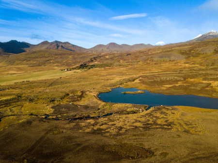 Aerial perspective of snaefellsnes peninsula, featuring volcanic peaks, a lake, and a river winding through the picturesque autumn scenery in icelandの写真素材