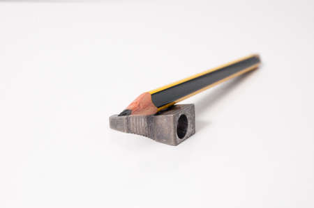 Pencil with an old metal sharpener  White background の写真素材