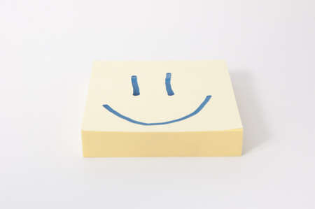 note with a smiley face  White background の写真素材