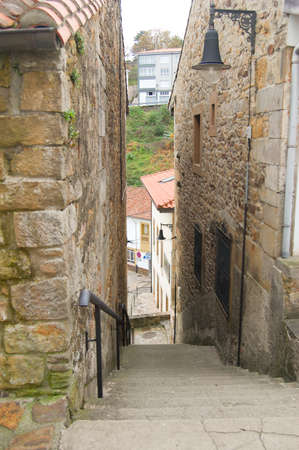 Narrow stone street with stairs. Located in Lastres, a maritime village in Asturias, North Spain.の写真素材