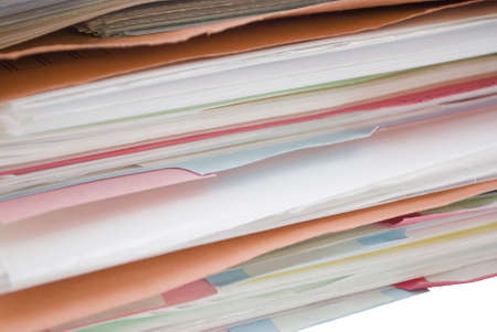 Pile of cardboard folders filled with papers and dividers- colours: blue, orange and pink.  Divider...