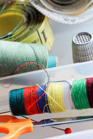 Close up of sewing items in the compartments of a sewing box. Unstaged and so naturaly scattered. 
