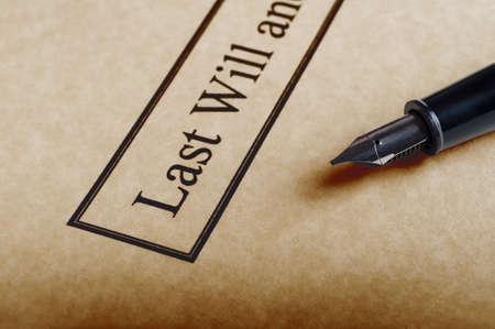 Close up of the bordered title of a last Will and Testament set on parchment paper with nib of fountain pen to the right.の写真素材