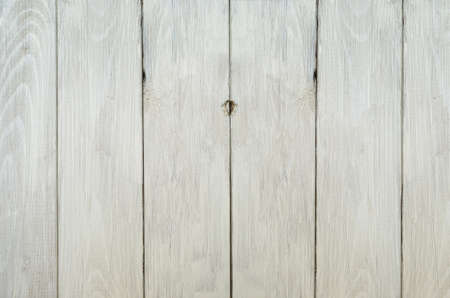 Background texture of a weathered old planked wood fence, liightly painted in  off-white paint.の写真素材
