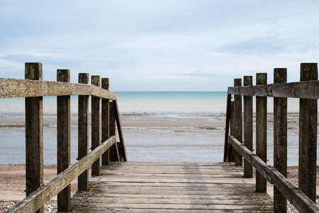 Shot taken from point of view of standing on a wooden bridge, looking out towards the horizon at the...