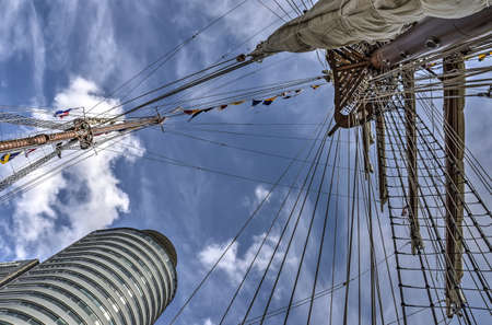 Rotterdam, The Netherlands, August 9, 2017: View up from Peruvian navy ship Bap Union, moored at Wilhelminapier towards one of the four masts and the enarby World Port Centerのeditorial素材