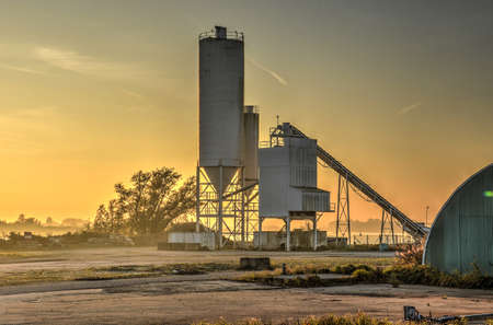 Barendrecht, The Netherlands, November 1, 2015: Small grainsilo at the bank of the Oude Maas river at sunsetのeditorial素材