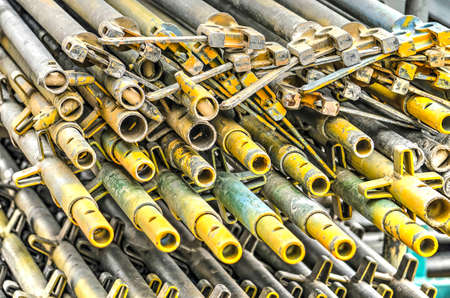 Stack of scaffolding pipes on a building site