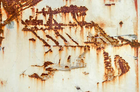 White painted metal surface with scratches and patches of rust