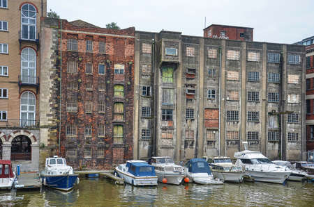 Bristol, England, May31, 2014: Yachts moored in the floating harbour against the backdrop of old warehousesのeditorial素材