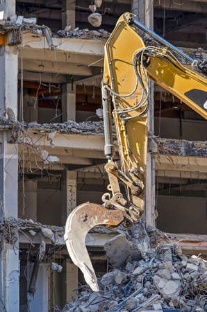 Arm of an excavator at the demolition site of a former office building in Rotterdamの写真素材