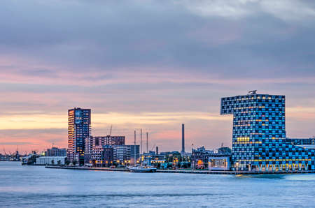 Rotterdam, The Netherlands, October 12, 2018: Colorful evening sky over the Lloydkwartier riverfront development with educational and residential buildingsのeditorial素材