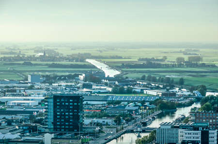 Leeuwarden, The Netherlands, November 3, 2018: aerial view of western neighbourhoods, mainly industrial, retail and offices, with the adjacent countryside disappearing in a distant hazeのeditorial素材