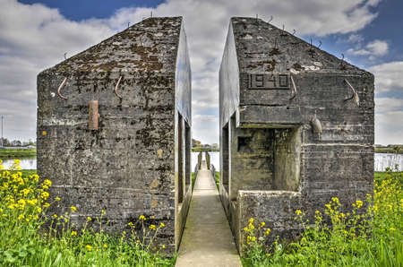 Culemborg, The Netherlands, April 8, 2018: Walking path through sawed open bunker 599, heritage from the era of the Dutch water line inundation systemのeditorial素材