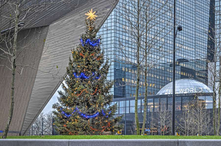 Rotterdam, The Netherlands, December 15, 2016: the large Christmas tree on the square in front of the Central Station, with Delftse Poort office building in the backgroundのeditorial素材