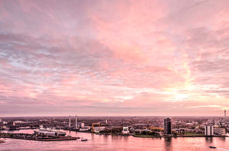 Rotterdam, The Netherlands, November 12, 2018: a pink sky at sunset over the harbours and neighbourhoods on the south bank of the river Nieuwe Maasのeditorial素材