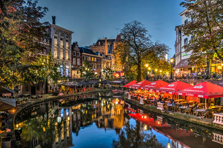 Utrecht, The Netherlands, September 30, 2017: houses, trees and outdoor cafes reflecting in the Oude Gracht (Old Canal) on a beautiful evening in autumnのeditorial素材