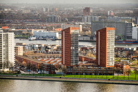 Rotterdam, The Netherlands, December 10, 2018: red brick residential complex with two towers as well as low-rise blocks on the peninsula of Katendrechtのeditorial素材