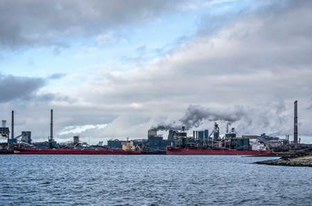 IJmuiden, The Netherlands, December 22, 2018: view across Northsea Canal towards the Tata steelworks under a dramatic skyのeditorial素材
