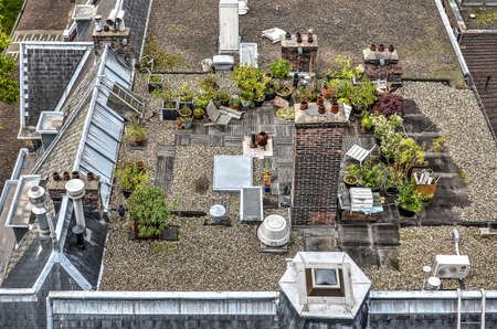 Rotterdam, The Netherlands, September 12, 2015:garden on a flat gravel-covered rooftop with wooden...
