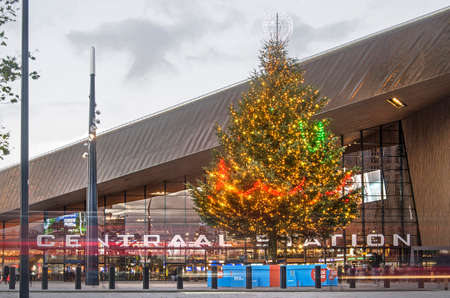 Rotterdam, The Netherlands, December 11, 2018: large christmas tree in front of the central railway station at duskのeditorial素材