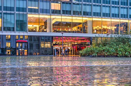 Rotterdam, The Netherlands, January 11, 2019: wet cobblestones on Gelderseplein square reflect the facade of a hotel on a rainy morning just before sunriseのeditorial素材