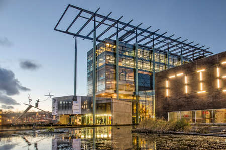 Rotterdam, The Netherlands, December 17, 2018: the New Institute, formerly architecture institute, in Museumpark, reflecting in the adjacent pond at duskのeditorial素材