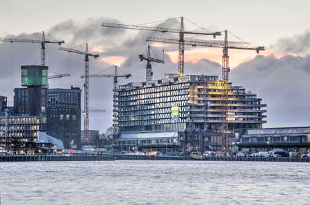 Rotterdam, The Netherlands, January 14, 2019: view across the river Nieuwe Maas towards the construction site of Fenixlofts, residential building on top of historic warehousesのeditorial素材