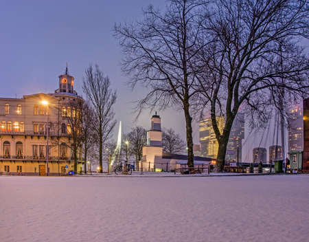 Rotterdam, The Netherlands, February 1, 2019: snow on the Veerhaven quay in the blue hour before sunrise, with the World Museum, Erasmus bridge and De Rotterdam building in the backgroundのeditorial素材