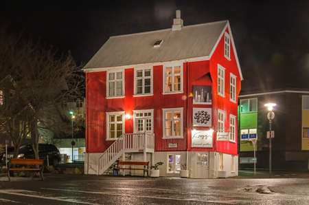 Reykjavik, Iceland, February 25, 2019: night view of a traditional house with corrugated metal facade, painted red, on a street in the city centerのeditorial素材